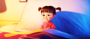 A little girl is resting in a bed.