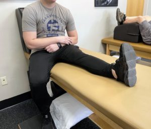 Seated hamstring stretch by a man