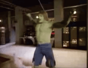 The hulk, with his massive bicep, is dancing in a room.