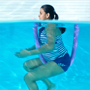 A pregnant woman swimming in a pool.