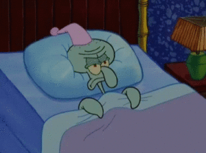 A spongebob squarepants character sleeping in bed with a hat on his head.