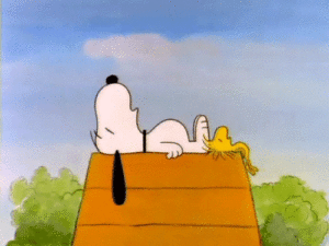 Snoopy sleeping on a roof.