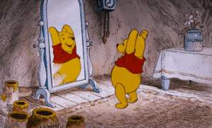 Winnie the pooh admiring his swell reflection in front of a mirror.